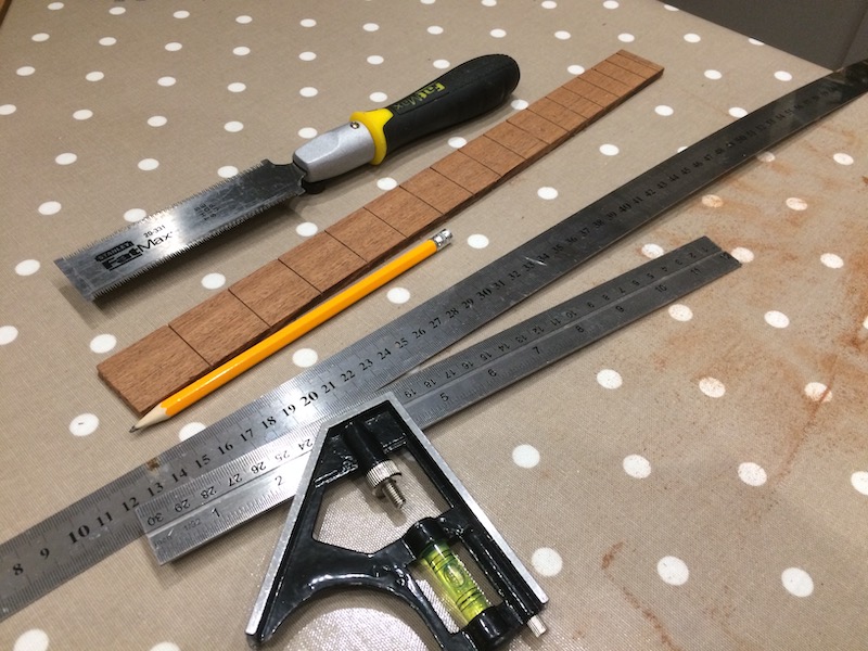 Cutting the slots for the frets with a Stanley Fat Max saw, using the [fret position calculator at Stewmac](https://www.stewmac.com/FretCalculator) to do the maths.
